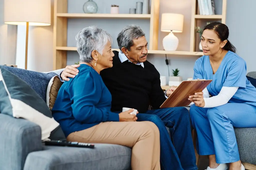 Shot of a cheerful elderly couple having a conversation with a female nurse inside of a doctor's office during the day