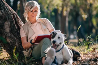 woman with a dog sitting outside