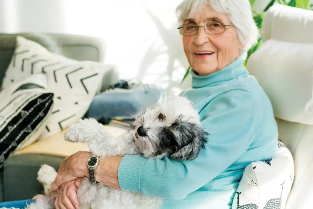 elderly lady holding a dog